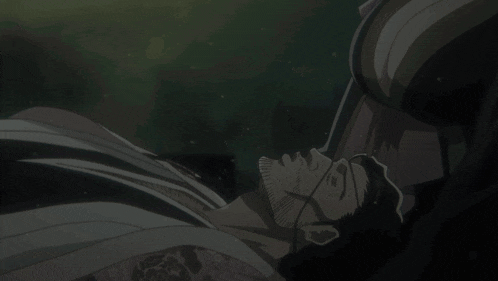 a man with a beard and glasses is laying down with his eyes closed