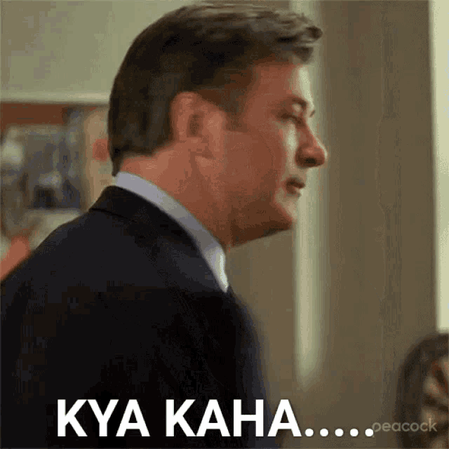 a man in a suit and tie is saying kya kaha .