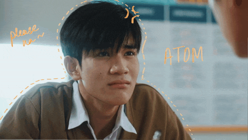 a young man with the word atom written on the bottom of his face