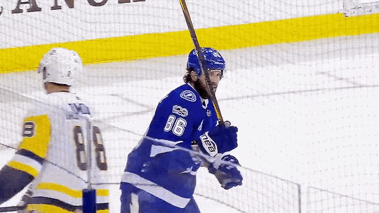 a hockey player with the number 86 on his jersey is holding a stick