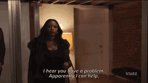 a woman is standing in a room and talking to a man .