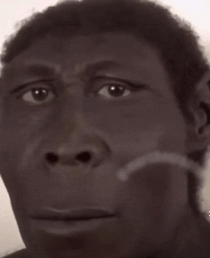 a close up of a man 's face with a hand on his chin