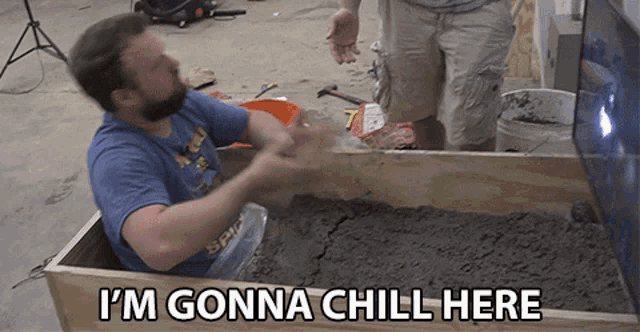a man sitting in a wooden box with the words i 'm gonna chill here