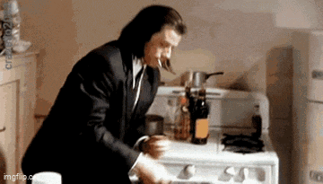 a man in a suit is cooking on a stove .