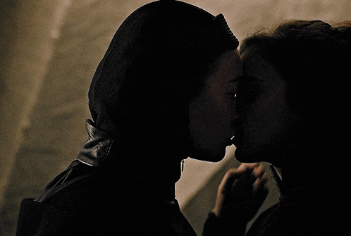 a man and woman are kissing in the dark