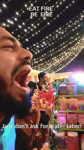 a man with his mouth open and the words eat fire be fire above him