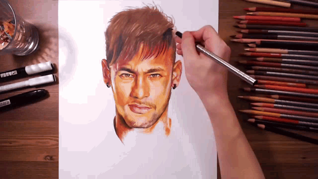 a person is drawing a picture of a man 's face with colored pencils and markers on the table