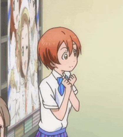 a cartoon girl with red hair is standing in front of a wall with a picture of a girl on it .