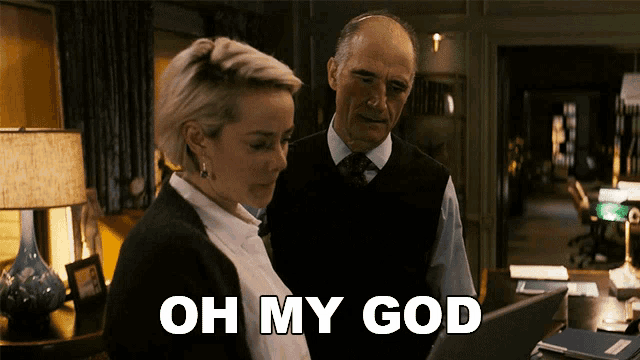 a man and a woman are looking at a laptop and the woman is saying " oh my god "