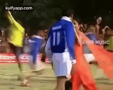 a group of soccer players are walking on a field . one of the players is wearing a number 10 jersey .