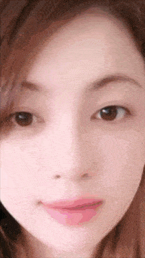 a close up of a woman 's face with pink lips