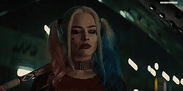 harley quinn from suicide squad is holding a bat in her hand