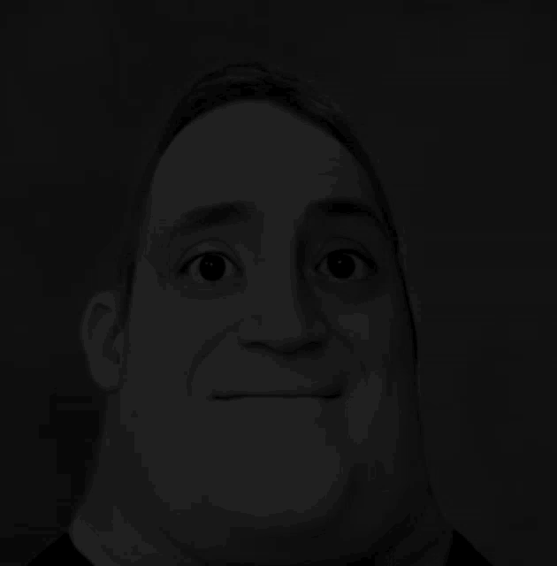 a man 's face is shown in a black and white image