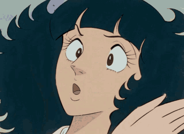 a close up of a woman 's face with a big smile on her face