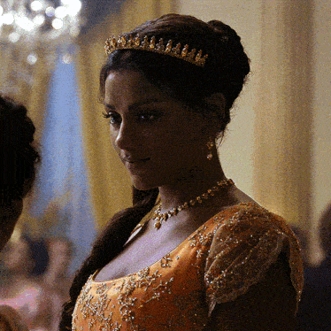 a woman wearing a tiara and a necklace is smiling