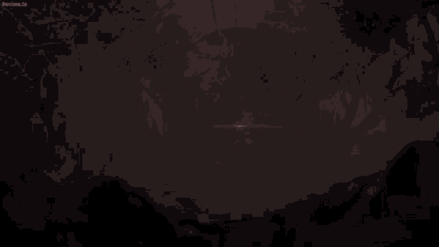 a person with red eyes is holding a knife in a dark room .
