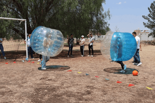a group of people are playing a game of bubble soccer