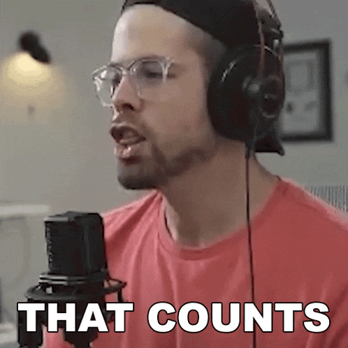 a man wearing headphones is singing into a microphone and the words that counts are visible