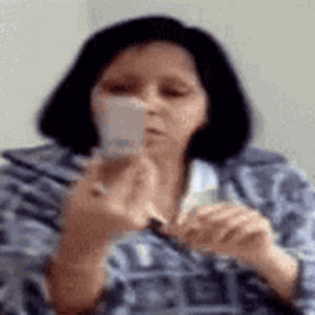 a woman is holding a piece of paper in her hand .
