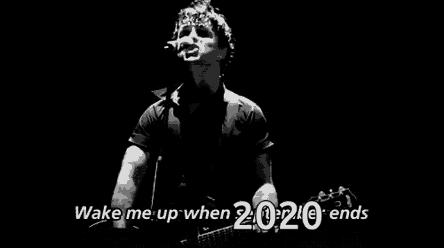 a man is singing into a microphone while playing a guitar .