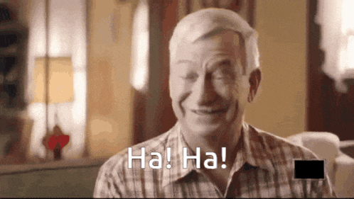 a man in a plaid shirt is laughing with the words ha ! ha ! below him