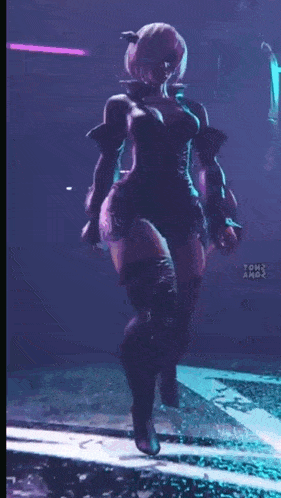 a woman in a black dress and thigh high boots is dancing on a stage .