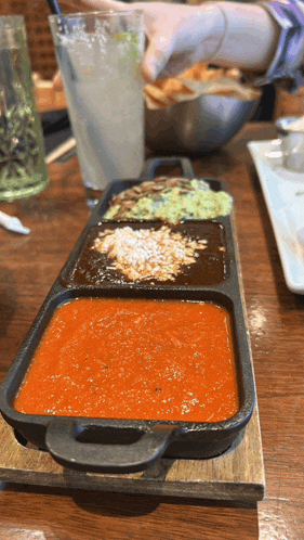 a tray of different sauces on a table