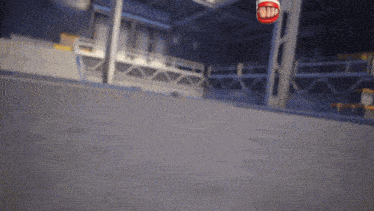 a red stop sign is hanging from a metal pole