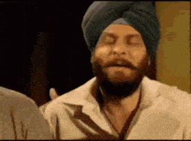 a man with a beard wearing a turban and a white shirt