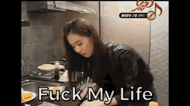 a woman is cooking in a kitchen and the words fuck my life are visible