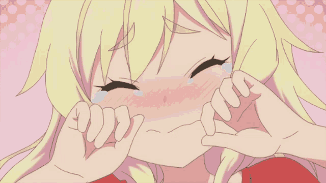 a girl with blonde hair is crying with her eyes closed