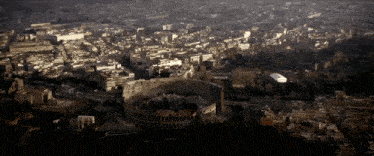 an aerial view of a city with the colosseum in the center