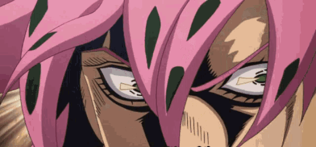 a close up of a person 's face with pink hair and green eyes
