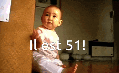 a baby is sitting in front of a door with the words il est 51 on the bottom