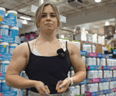 a woman is standing in front of a display of collagen