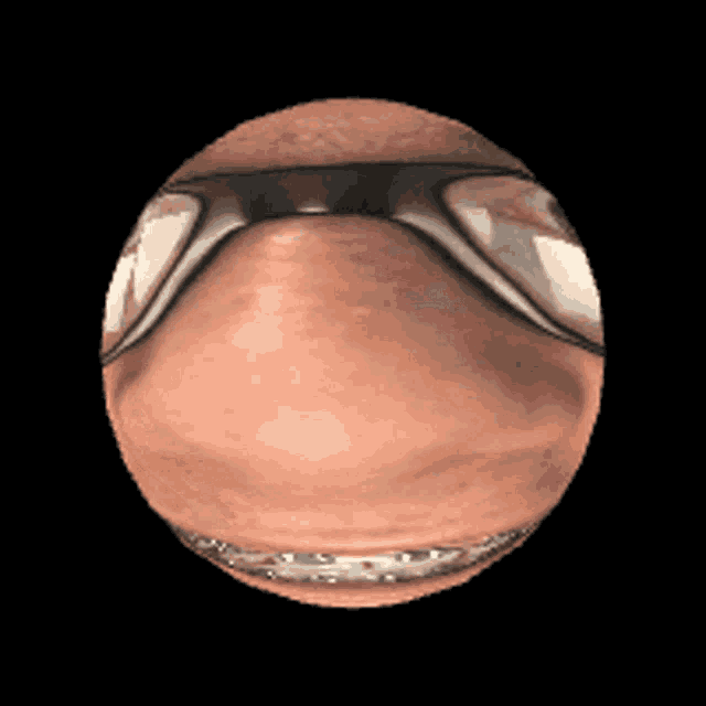 a close up of a person 's face with glasses on