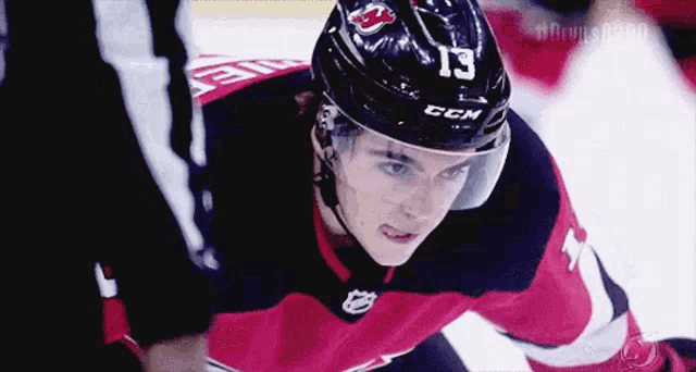 a hockey player wearing a helmet that says ccm on it