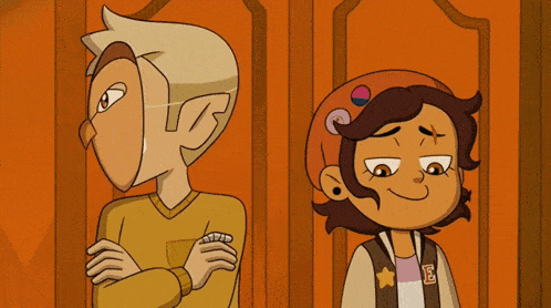 a boy and a girl are standing next to each other in front of an orange door