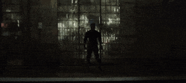 a man with a beard stands in front of a window and says hello there