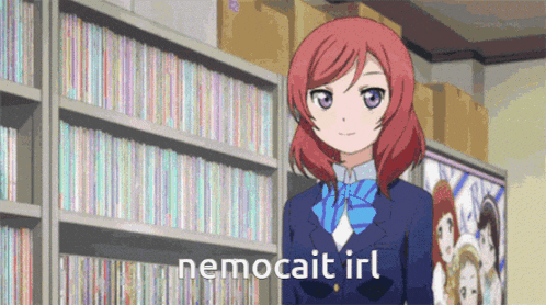 a girl in a school uniform is standing in front of a bookshelf with the words nemocat irl written on it