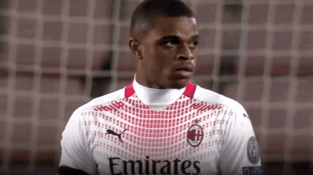 a soccer player wearing a white emirates jersey