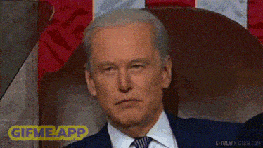 a man in a suit and tie is smiling with a gif me app sticker