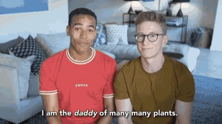 two men are sitting next to each other and one of them is saying i am the daddy of many many plants