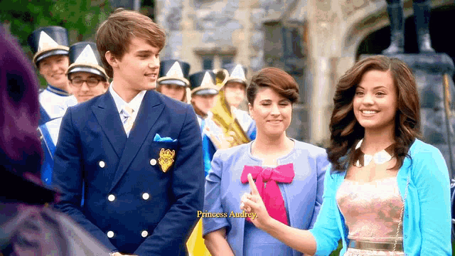 a group of people standing next to each other with princess audrey written in yellow