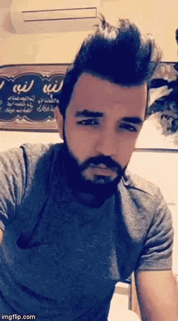 a man with a beard is looking at the camera with a sign behind him that says imgflip.com
