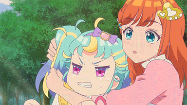 a girl in a pink dress is holding a girl in a blue and yellow ponytail