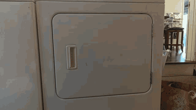 a white washer and dryer with the door open and a sticker on the door that says ' lg '