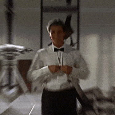 a man in a white shirt and black bow tie