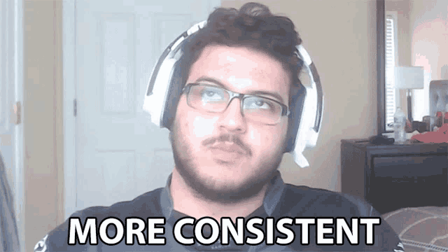 a man wearing headphones says more consistent in front of a door