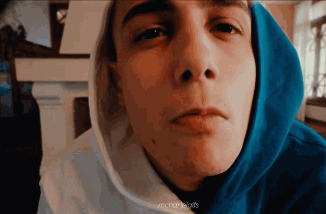 a close up of a man 's face with the words mchane gifs below it